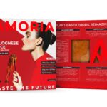 Amoria Bolognese Mince plant-based packaging, front and back panels in bold red design, with a woman holding spaghetti, nutrition facts, ingredients, and product viewing window.