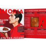Amoria Chilli Con Carne plant-based packaging, front and back panels in bold red design, with a man holding a plate of rice and chilli, nutrition facts, ingredients, and product viewing window.