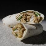 Sliced plant-based chicken shawarma wrap filled with vegan chicken, greens, and dairy-free garlic sauce – Amoria Foods