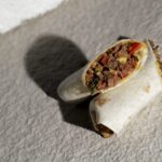 Sliced plant-based Mexican wrap filled with vegan beef, tomatoes, onion, and herbs – Amoria Foods