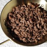 Raw plant-based minced beef in a brass pan – Amoria Foods vegan beef alternative