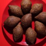 Top-down view of plant-based Kibbeh arranged on a red plate – Amoria Foods vegan meat alternative