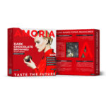 Amoria Dark Chocolate Brownies plant-based packaging, front and back panels in bold red design, with a woman holding a brownie, nutrition facts, ingredients, and product viewing window.
